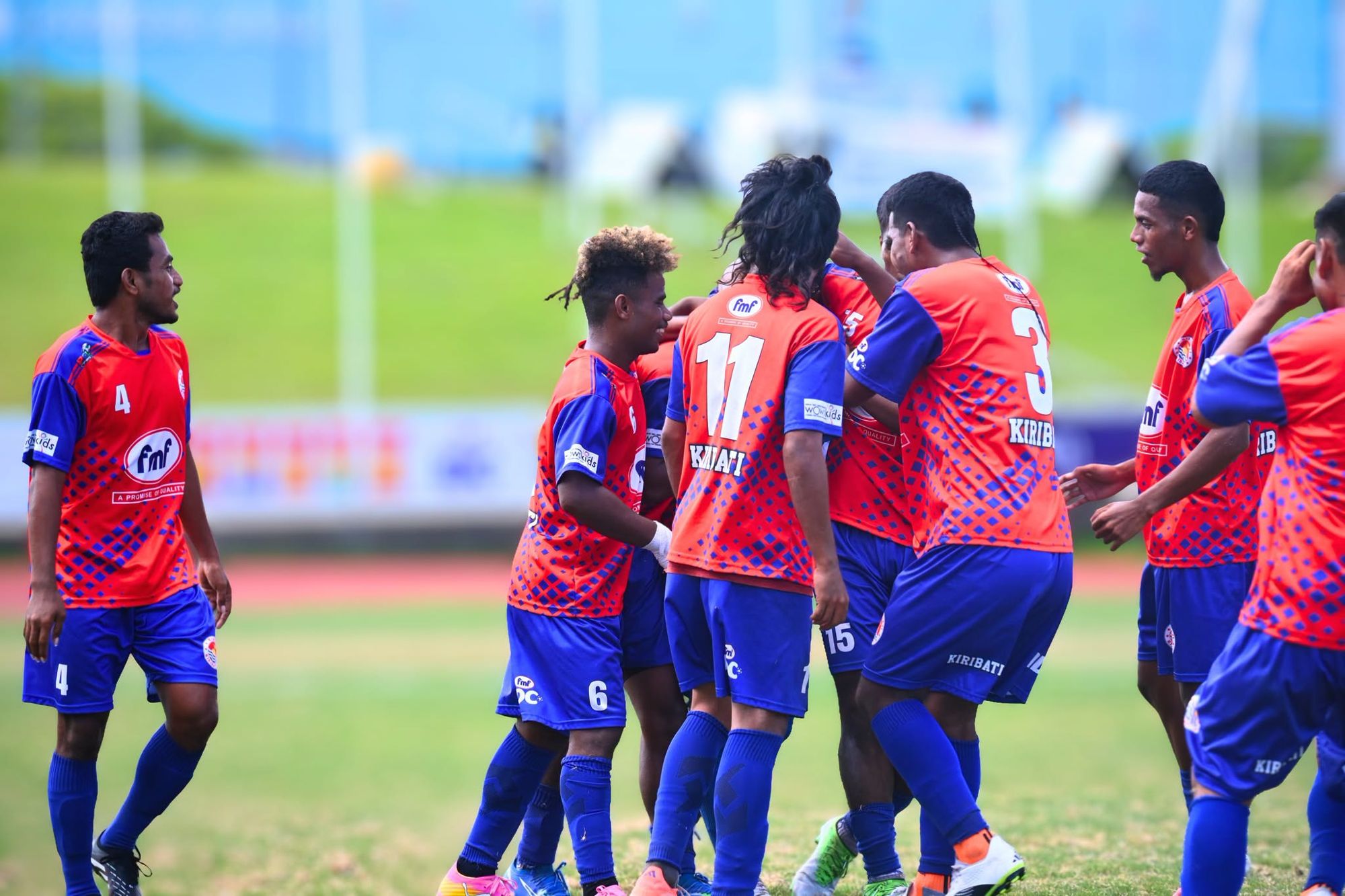 Kiribati players celebrate together on the pitch